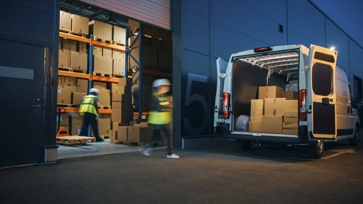 Business logistics and supply chain management process with workers loading and unloading boxes in a warehouse and delivery van.